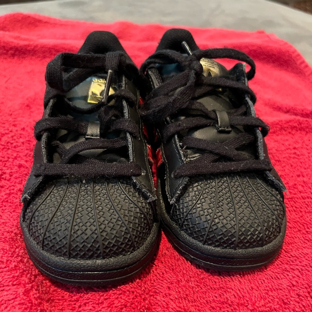 Black Adidas with red stripe